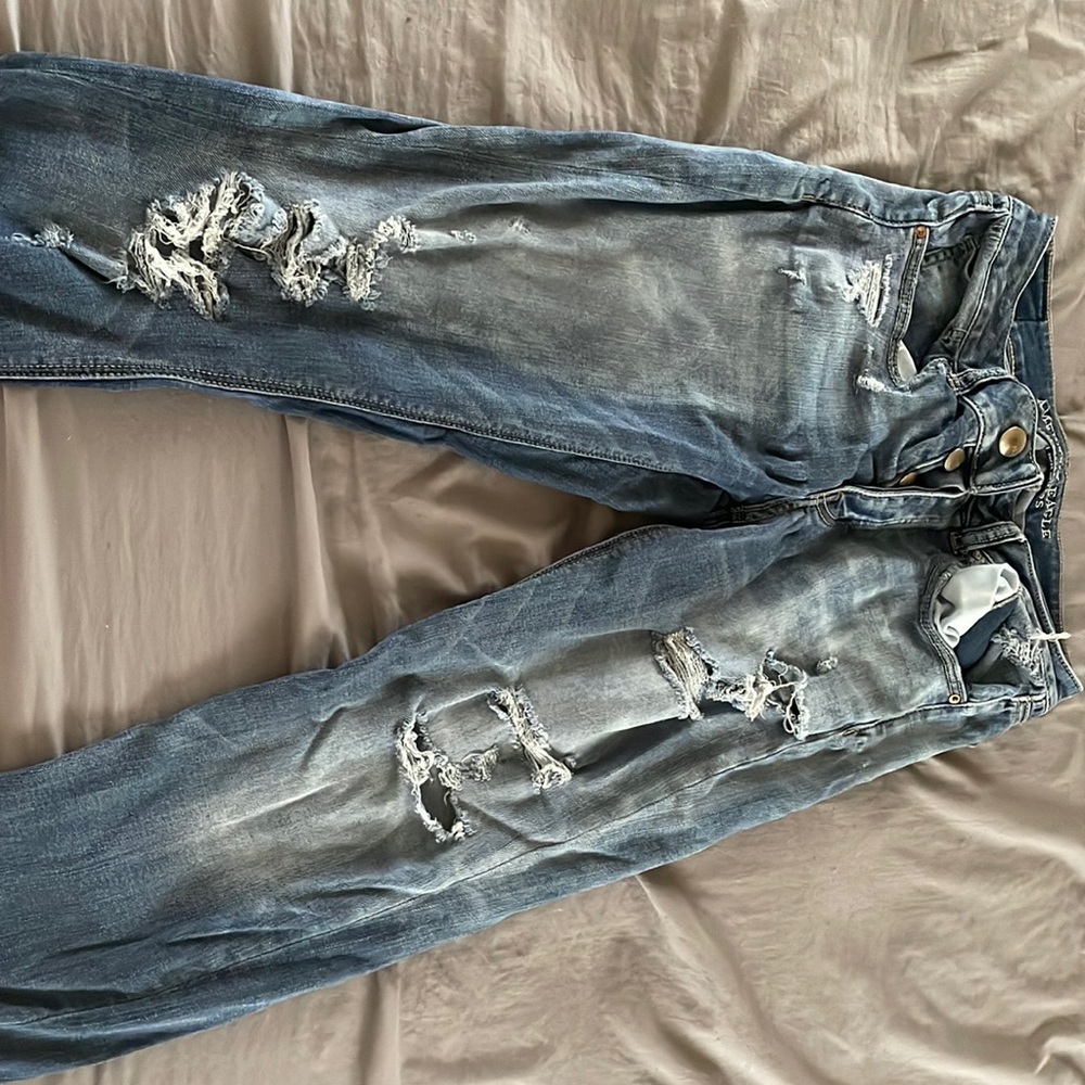 Dark blue jeans lots of ripped holes